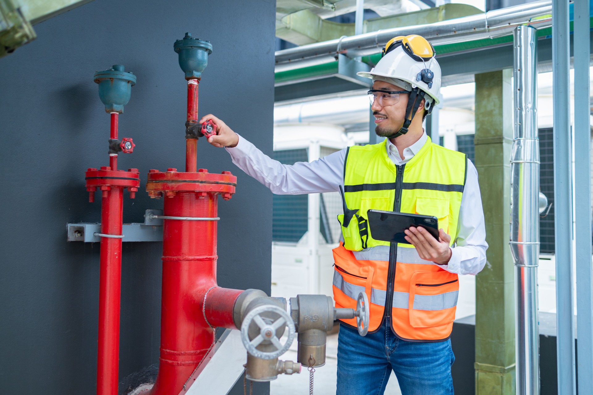 Engineer under industrial examination Fire pump machine of large industrial buildings to control fire prevention